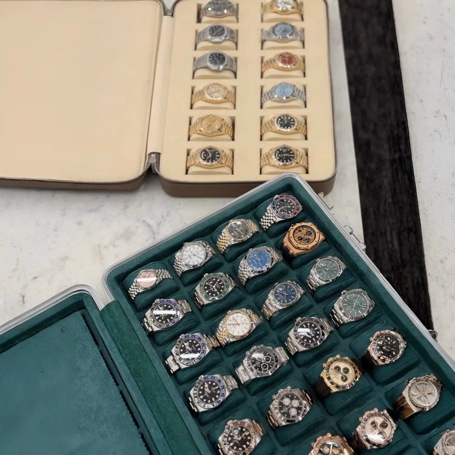 Collection of luxury watches in cases.